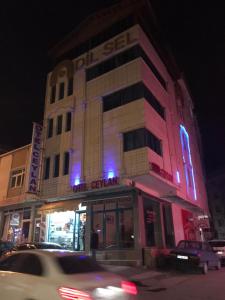 a building with purple and blue lights on it at Ceylan otel in Suşehri