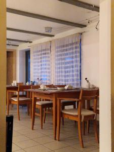 a dining room with wooden tables and chairs at Hotel Beere in Salzwedel