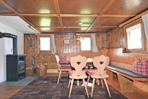 a dining room with a table and chairs and a stove at UNSER VORSÄSS - Klausberg in Schwarzenberg +16 photos