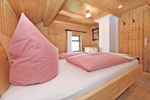 a bedroom with two pink pillows on a bed at UNSER VORSÄSS - Klausberg in Schwarzenberg