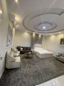 a living room with a bed and a couch at ADEL Privet Hostleإيواء خاص in Taif +26 photos