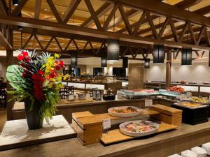 a large kitchen with many plates of food and flowers at Atami Seaside Spa & Resort in Atami