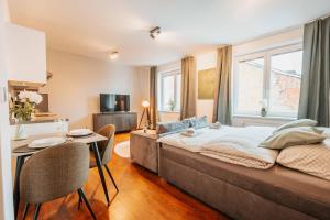 a bedroom with a bed and a table and chairs at CityBeat Apartments, 400m from the square in Pilsen