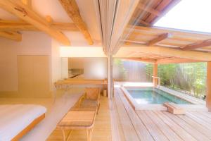 a house with a swimming pool in the middle of a room at 御宿竹林亭 in Takeo +22 photos