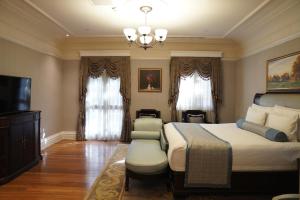 a bedroom with a large bed and a chandelier at Villa Morriss Residence - D'CONG Heritage in Shanghai
