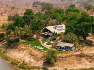an aerial view of a house on a hill next to a river at Sian-simba-river-lodge in Victoria Falls