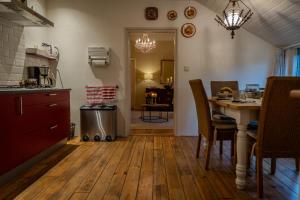 a kitchen with a table and a dining room at Vledderstee in Vledderveen
