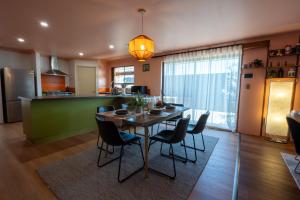 a dining room and kitchen with a table and chairs at Spearwood Little Getaway in Spearwood
