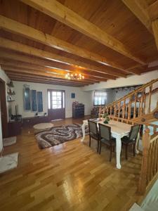 a large living room with a table and chairs at Gem Guest House in Lazarat