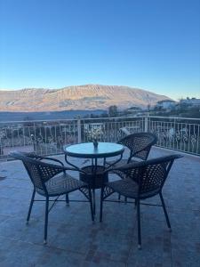 a table and chairs sitting on a patio at Gem Guest House in Lazarat