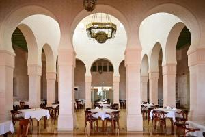 a dining room with tables and chairs and a chandelier at Hotel Nour Palace Resort & Thalasso Mahdia in Mahdia +78 photos