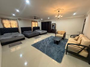 a large living room with a couch and a rug at Megrram Homestay Ipoh-entire bungalow for 32 pax in Ipoh