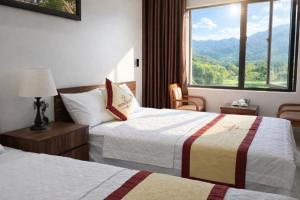 a hotel room with two beds and a large window at Friend Hotel Hà Giang in Ha Giang