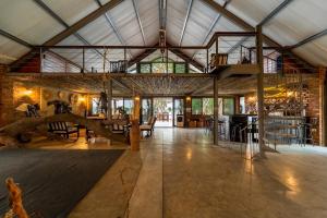 a large room with a loft with a staircase at Sian-simba-river-lodge in Victoria Falls