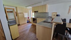 a kitchen with a sink and a counter top at Ferienwohnung Tulipana in Müstair +3 photos