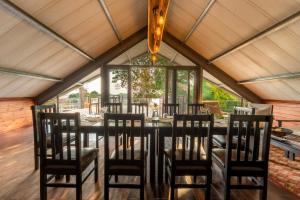 a dining room with a table and chairs at Sian-simba-river-lodge in Victoria Falls