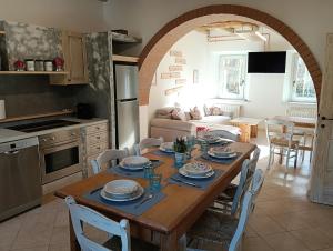 a kitchen and dining room with a table and chairs at La Casa dei Nonni in Caralte