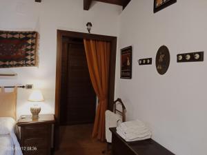 a bedroom with a bed and a door with an orange curtain at Villa Amalia - mansarda B&B in Cinisi