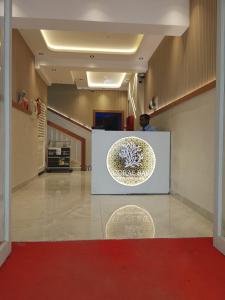 a man standing at a counter in a hospital lobby at Coral Bay Suite Hotel in Khor Fakkan
