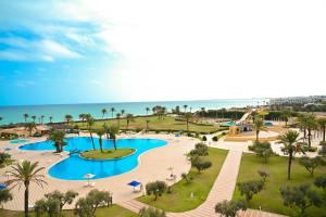 an aerial view of a resort with a swimming pool and the ocean at Hotel Nour Palace Resort & Thalasso Mahdia in Mahdia