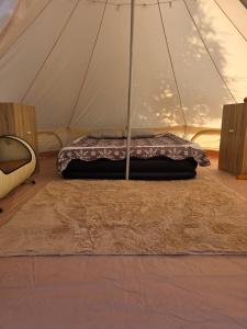 a mattress in a tent with a rug at KNM Living Home in Pai
