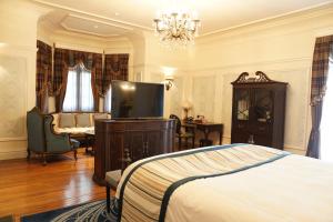 a bedroom with a bed and a flat screen tv at Villa Morriss Residence - D'CONG Heritage in Shanghai