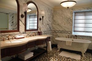 a bathroom with two sinks and a tub and a mirror at Villa Morriss Residence - D'CONG Heritage in Shanghai +22 photos