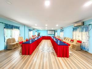 a large conference room with a long table with red table cloth at Chitwan Forest Resort with swimming pool , Chitwan National Park in Sauraha