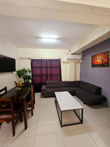 a living room with a couch and a table at Aurora Mirage Apartments in Nadi