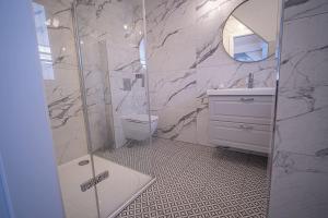 a bathroom with a shower and a toilet and a sink at Apartmány Harmony Liptov - City Center & Private Wellness in Liptovský Mikuláš +49 photos