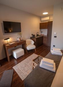 a living room with a desk and a kitchen at Monastiri Mountain Escape in Konitsa +50 photos
