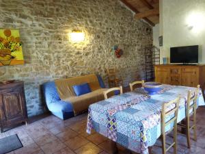 a living room with a table and a couch at Gîte Le Provençal in Vagnas