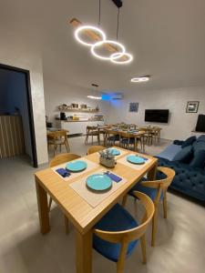 a dining room and living room with a table and chairs at Donatella Apartment 2 in Podstrana