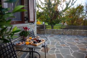 a tray of food on a table on a patio at Monastiri Mountain Escape in Konitsa