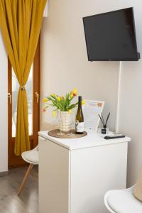 a white cabinet with a bottle of wine and a plant at Sipos Borház és Vendégház in Badacsonyörs