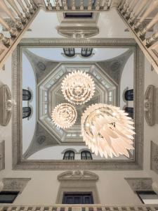 two chandeliers hanging from a ceiling in a building at Hospes Palacio de los Patos, a Member of Design Hotels in Granada