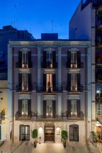 a large white building with windows and balconies at VIS urban suites & spa - Boutique Hotel in Bari
