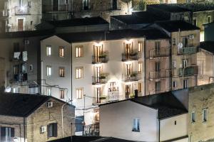 an apartment building with lights on in a city at Paladini al Casale in Piazza Armerina