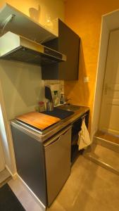 a small kitchen with a sink and a stove at ENTRE PIERRE ET BOIS in Saint-Savinien +8 photos