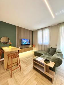 a living room with a couch and a table at Valcamonica Apartments - Lake in Boario Terme