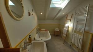 a bathroom with a sink and a toilet and a mirror at ENTRE PIERRE ET BOIS in Saint-Savinien