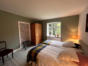 a bedroom with a large bed and a window at Højriisgaard B & B in Nørreby