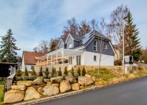a house with a lot of rocks in front of it at Ferienhaus Benedikt in Fichtelberg
