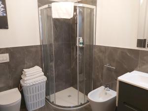 a bathroom with a shower and a toilet and a sink at Apartments Marini in Pordenone +18 photos