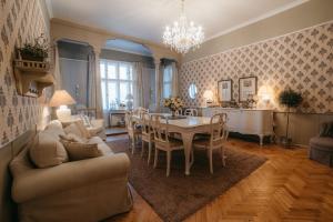 a living room with a table and a dining room at Château Josefův Důl in Josefŭv Dŭl
