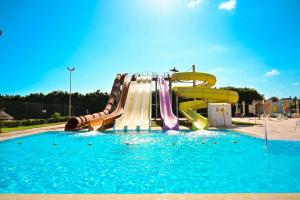a water slide in a pool in a park at Hotel Nour Palace Resort & Thalasso Mahdia in Mahdia