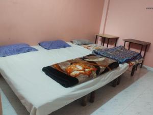 two twin beds in a room with two tables at affordable homes in Prayagraj