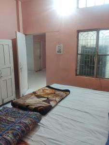 a room with a large bed in the corner of a room at affordable homes in Prayagraj