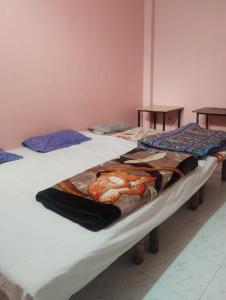 two twin beds in a room with avertisementforgrimgrimgrimgrimgrimgrim at affordable homes in Prayagraj