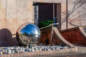 a large metal ball on the side of a building at Daresbury Park Hotel in Daresbury